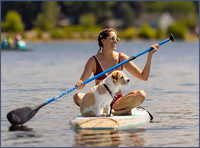Woman with Dog on Paddleboard